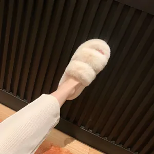 Faux fur thick-soled slide slippers in apricot color on wooden floor background