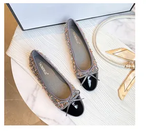 Detailed top view of tweed ballet flats with black patent leather toe and bow tie