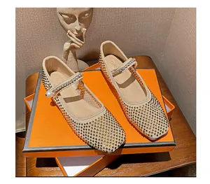 Detailed macro of gold rhinestones and pearl strap on square toe Mary Jane flats