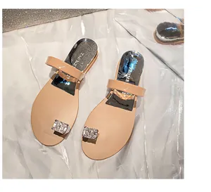 Detailed top view of nude toe-ring sandals with sparkling rhinestone buckle decoration