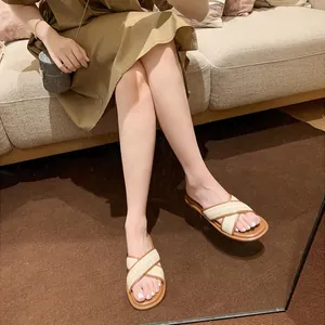 French vintage style women's slide sandals with cream woven cross straps and brown soles