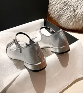 Detailed view of silver Mary Jane flat shoes with a rhinestone buckle and 3cm heel