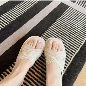 Women's cream platform slide sandals with woven cross straps and a thick sole
