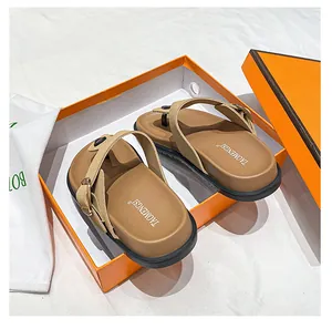 Brown flat sandals with adjustable gold metal buckle in premium orange gift box