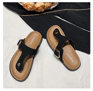 Detail of leather thong sandals with gold buckle and comfortable cushioned footbed