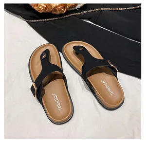 Detailed top view of women's thong slide sandals with gold buckle and brand logo