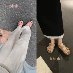 Pink and khaki double strap sandals with metallic buckles and thick black platform soles