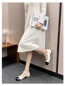 Classic two-tone Mary Jane flat shoe in beige and black with decorative pearl buckle