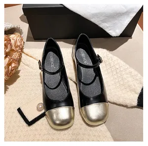 Close-up of black and gold Mary Jane flats with rhinestone buckle and elegant packaging