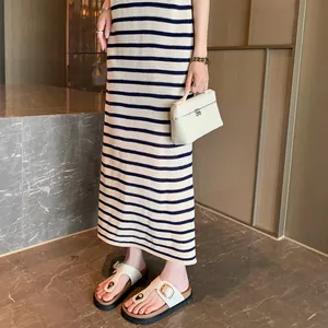 Women's leather buckle platform beach sandals styled with a striped knit maxi dress