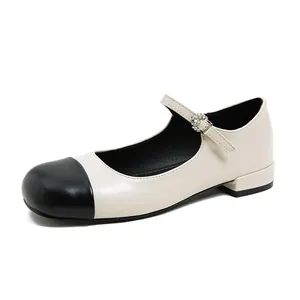 Elegant beige and black round toe Mary Jane flats with rhinestone buckle and low heel