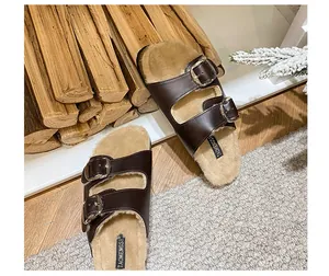 Detail of dark brown wool Birkenstock clogs with plush lining and metal buckles