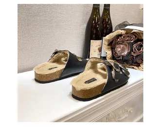 Detail of black faux leather mule with warm plush lining and adjustable metal buckles