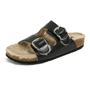 Women's black fur-lined Birkenstock style clogs with dual metal buckles and platform sole
