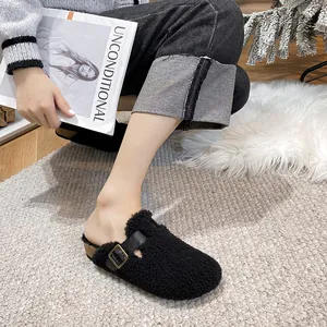 Retro black faux shearling Boston clogs with adjustable buckle and cork footbed