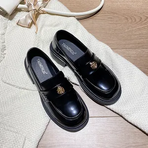 Glossy black patent leather platform loafers with gold camellia floral buckles for women
