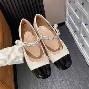 Elegant off-white Mary Jane flats with black patent leather toe and pearl chain detail