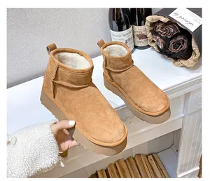 Close-up of camel suede platform snow boots featuring plush faux fur lining and thick soles