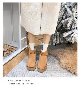 Close-up of brown suede mini platform snow boots styled with cozy winter socks and skirt