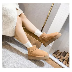 Detail of warm camel suede snow boots with thick platform soles in cozy winter setting
