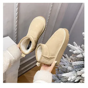 Close-up of khaki leather snow boots showing thick faux fur lining and platform sole
