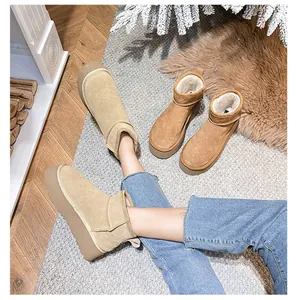 Detail view of khaki and brown platform snow boots with thick faux fur lining