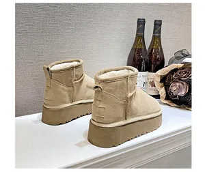 Detail of warm khaki suede snow boot with thick plush wool lining and platform sole