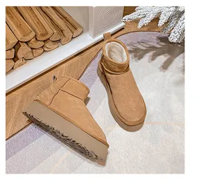 Detailed view of warm camel suede snow boots with thick white wool lining and durable soles
