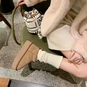 Women's brown platform sheepskin snow boots with warm wool lining and leather finish
