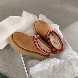 Suede platform slippers with wool lining and red woven trim in a shoebox