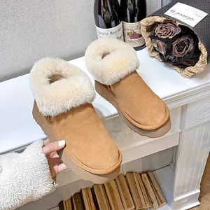Women's camel suede snow boots with thick soles and plush sheepskin lining details
