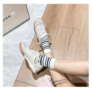 Top view of leather sneakers featuring retro gum soles and suede patchwork details
