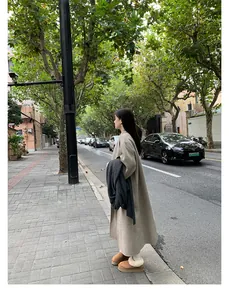 Street style shot of grey wool coat paired with camel platform plush snow boots