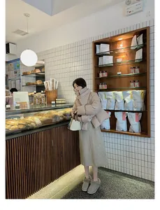 Chic grey platform faux fur slippers styled with a beige winter down jacket and skirt
