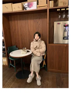 Winter outfit featuring grey genuine leather snow boots and a beige quilted jacket