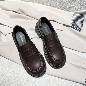 Classic dark brown leather loafers with star detail on flat heels, elegant style