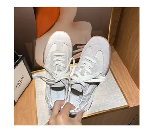 Top view of leather ballet sneakers featuring beige suede panels and gum rubber soles