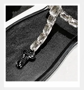 Detail of crystal embellishments and woven knot on women's casual thong sandals