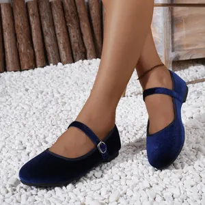 Navy blue velvet Mary Jane ballet flats with silver buckle on a natural stone background