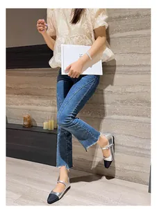 Chic silver Mary Jane flats with black contrast toe and buckle strap on a model