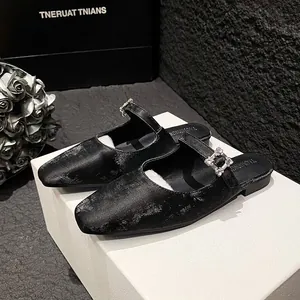 Elegant black square-toe mule flats with sparkling crystal buckle and metallic texture
