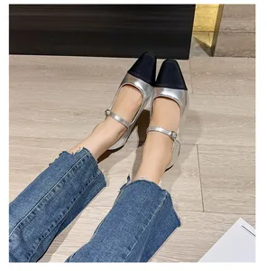 On-foot shot of elegant square-toe Mary Jane shoes with silver and black patchwork design