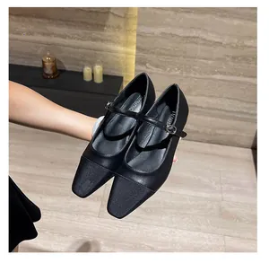 Detail view of square toe Mary Jane shoes featuring contrast panels and buckle strap