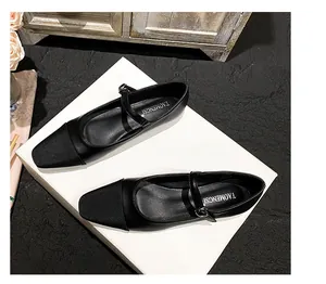 Detail of elegant two-tone square toe Mary Jane flat shoes with silver buckle strap