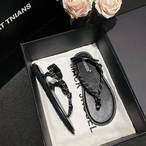 Women's black rope flip-flops with woven straps and premium gift box packaging