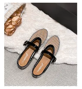 Detail view of breathable white mesh Mary Jane flats with black patent leather straps