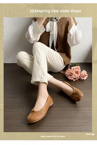 Detail of camel Tabi split-toe ballet flats with bow detail and soft leather finish