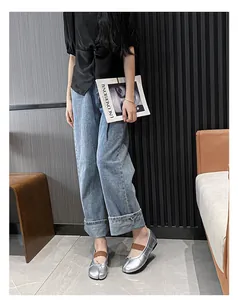 Silver Tabi flats with bow detail and elastic strap shown in a modern interior setting