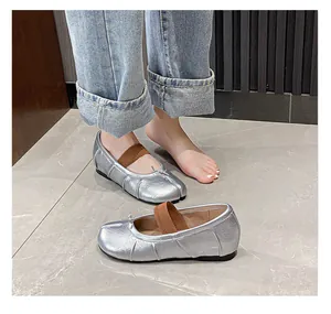 Close-up of silver metallic Tabi ballet flats featuring split-toe and bow detail