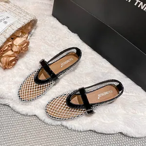 Breathable mesh Mary Jane flats in black and white with an adjustable buckle strap
